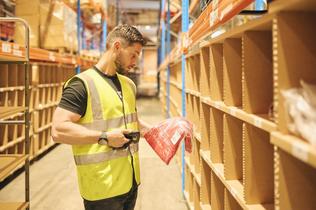 An employee at Delta Fulfilment picking an order for a client who uses our Amazon FBM Fulfilment Services, demonstrating how Amazon FBM works.