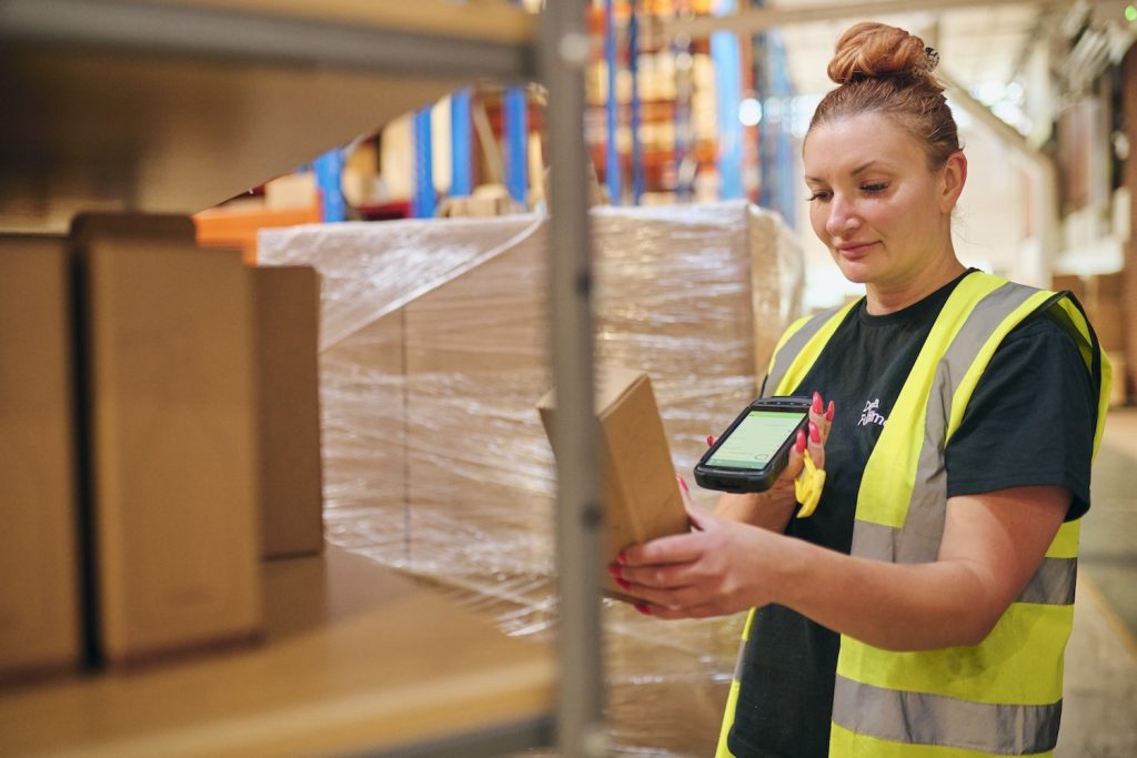 A Delta Fulfilment employee picking and packing products for a client using our Amazon Fulfilment Services.