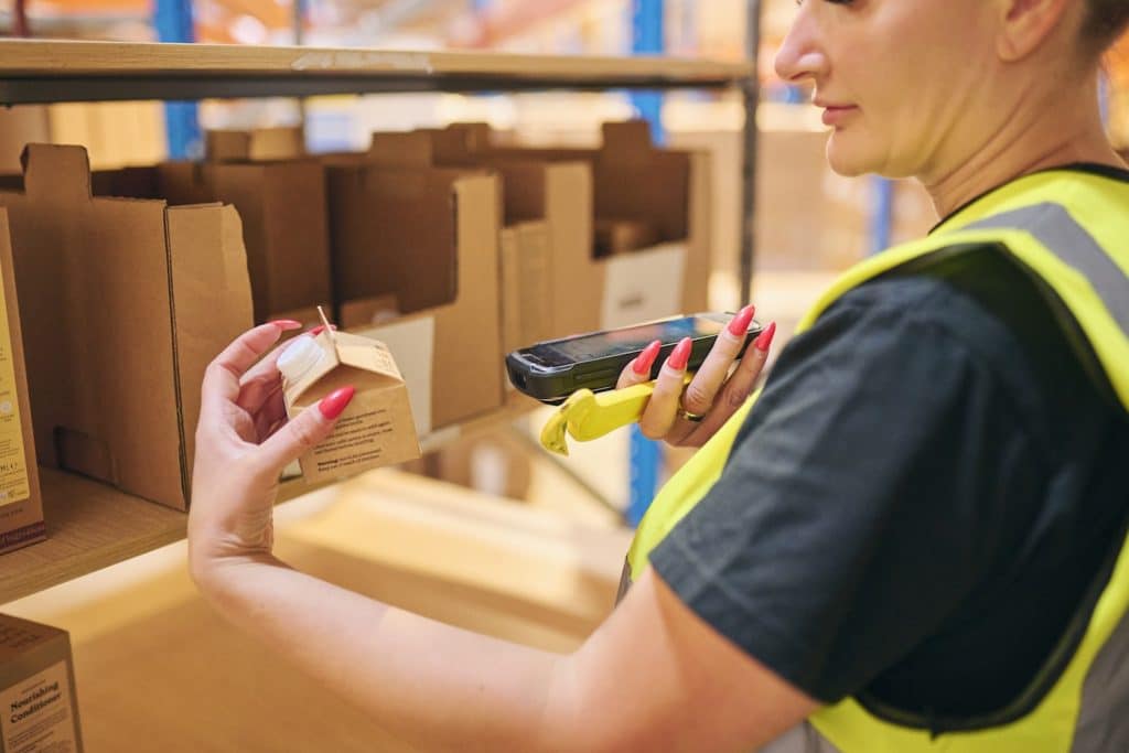 A Delta Fulfillment employee picking and packing a product as part of our Amazon FBA Prep Service for a small business. This business researched ‘How does Amazon FBA work?’ and decided to become an FBA seller with our support.