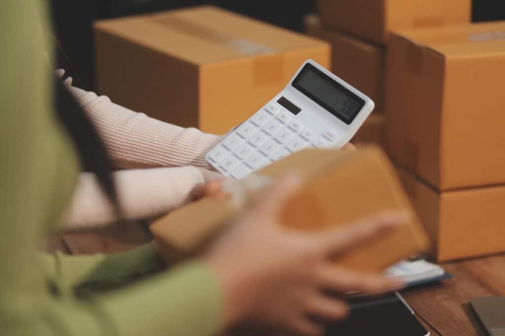 An eCommerce business owner calculating shipping costs.
