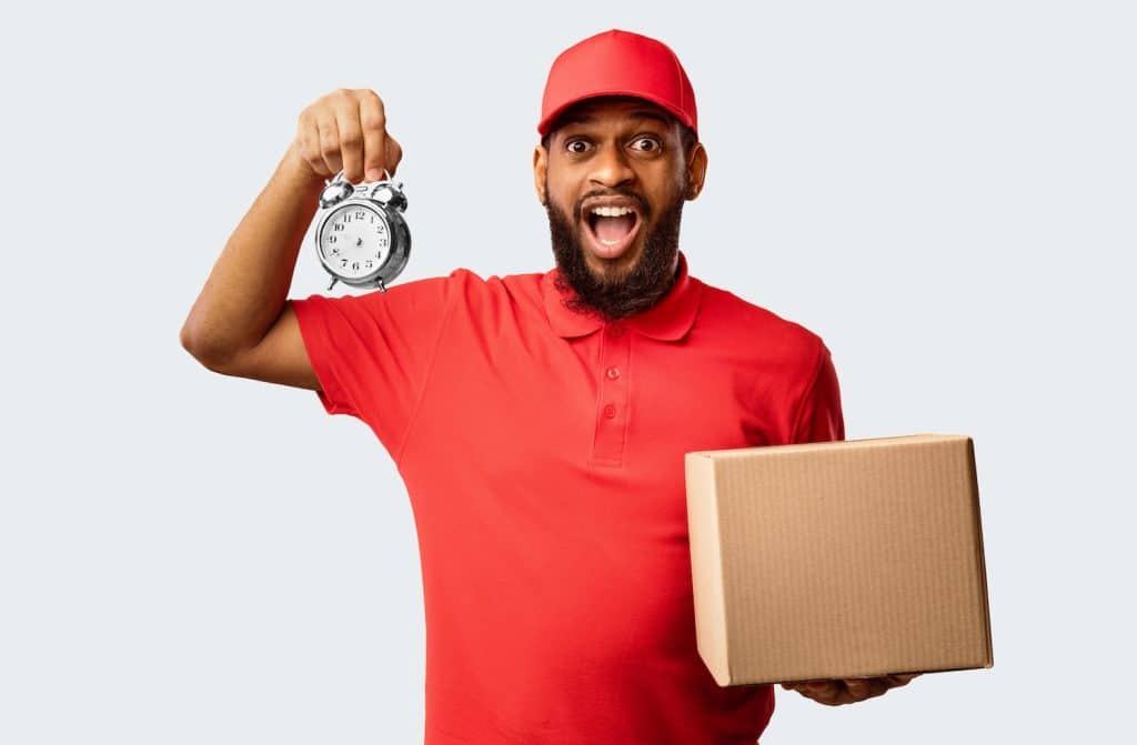 A delivery driver holding a clock and a package, expressing shipping delays