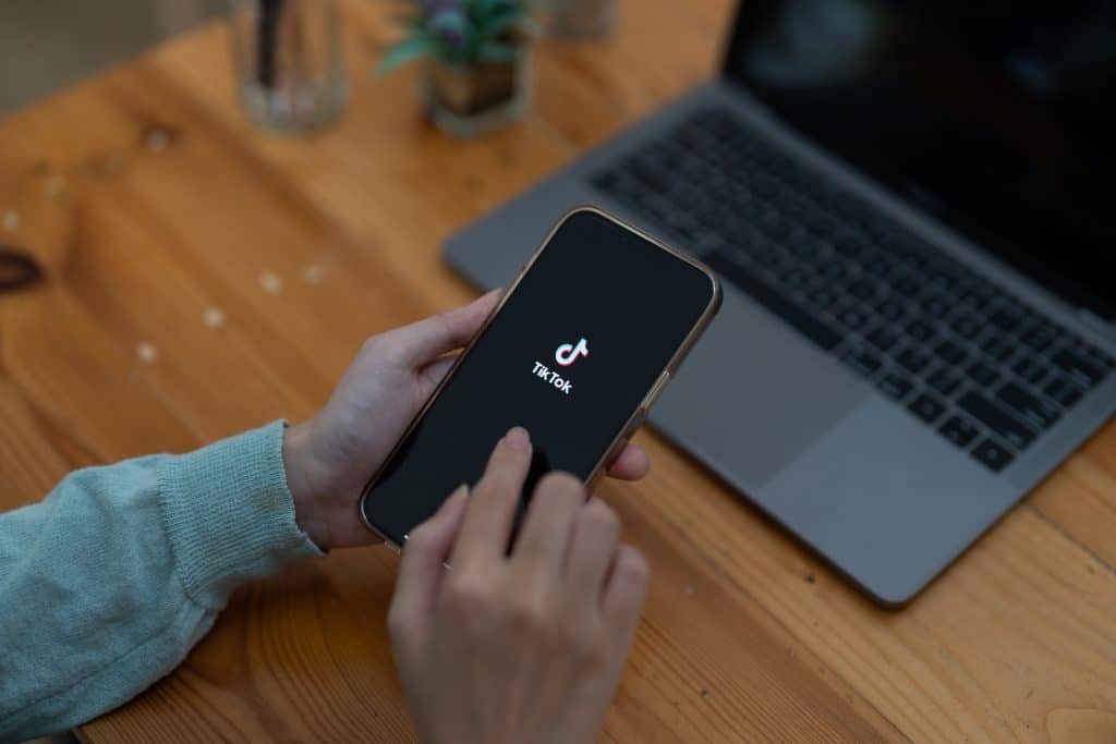 An eCommerce business owner logging on to TikTok to optimise their products to represent: ‘How to Get Your Products to Sell on TikTok Shop’