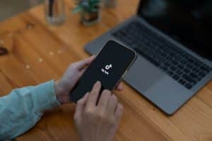 TikTok Fulfilment An eCommerce business owner logging on to TikTok to optimise their products to represent: ‘How to Get Your Products to Sell on TikTok Shop’
