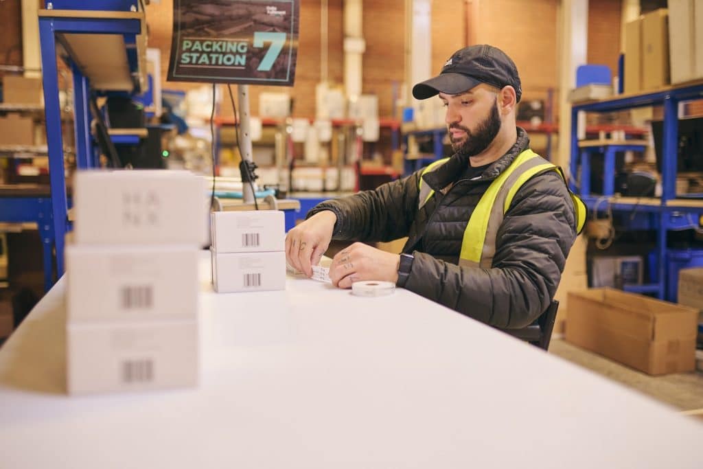 A Delta Fulfilment employee packing a shipment to represent 3PL vs 4PL.