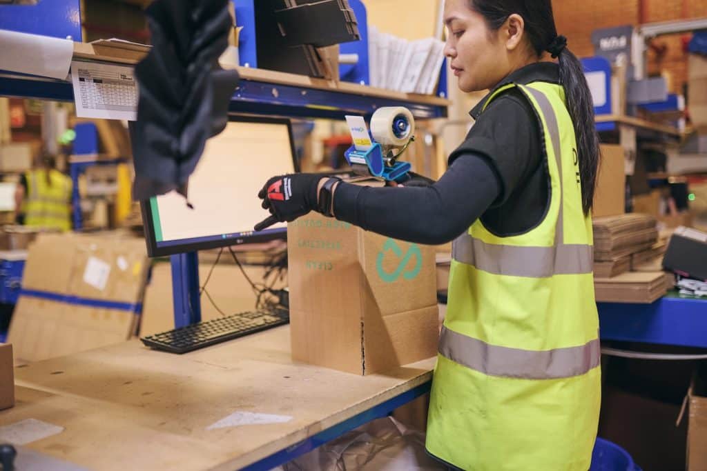 A Delta Fulfilment employee packing an order to represent ‘Outsourcing WooCommerce Fulfilment’